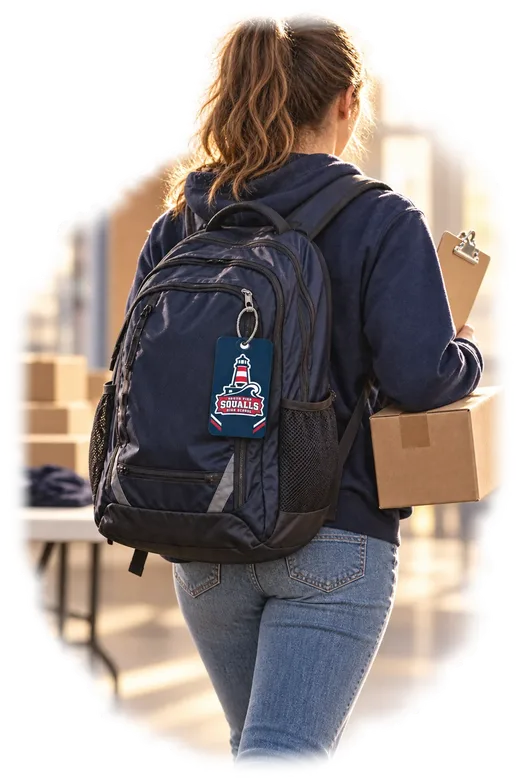 A student council volunteer setting up an event beside a tote carrying a South Pier school tag