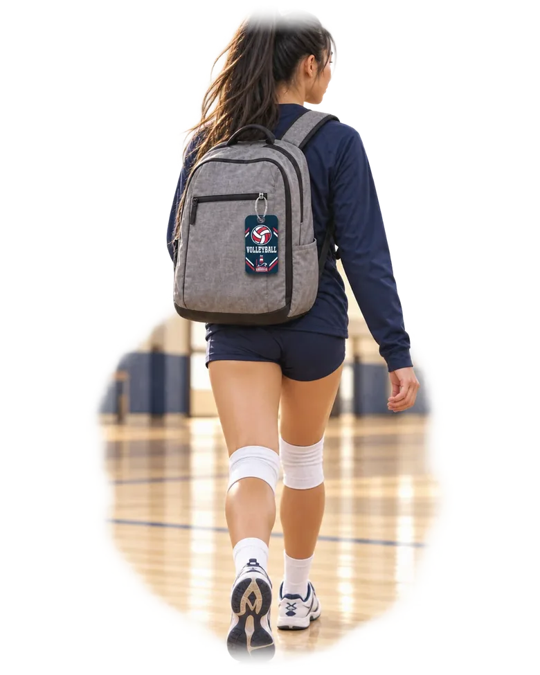A volleyball player walking out of the gym with a South Pier tag on her backpack