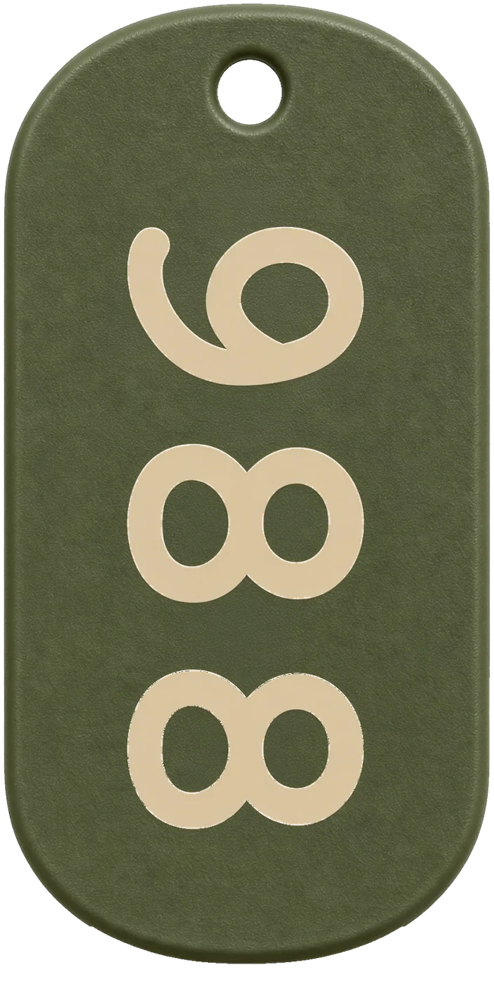 The 988 front: olive drab with the number 988 in tan, turned a quarter turn